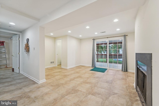 unfurnished living room with a fireplace, recessed lighting, and baseboards