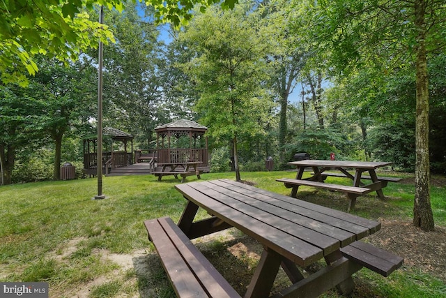 surrounding community with a lawn and a gazebo
