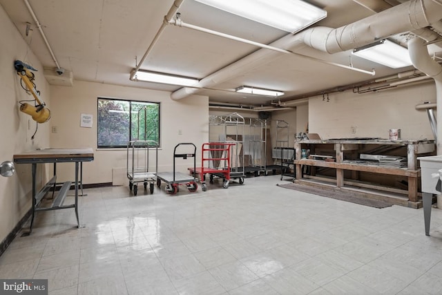 basement with tile patterned floors and baseboards