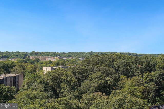exterior space featuring a wooded view