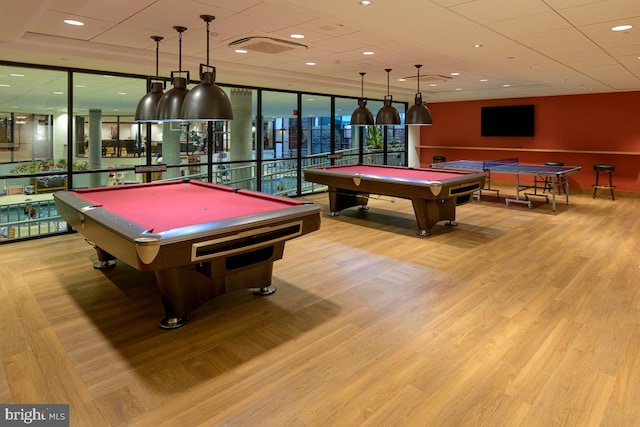 rec room with wood finished floors, floor to ceiling windows, recessed lighting, and billiards