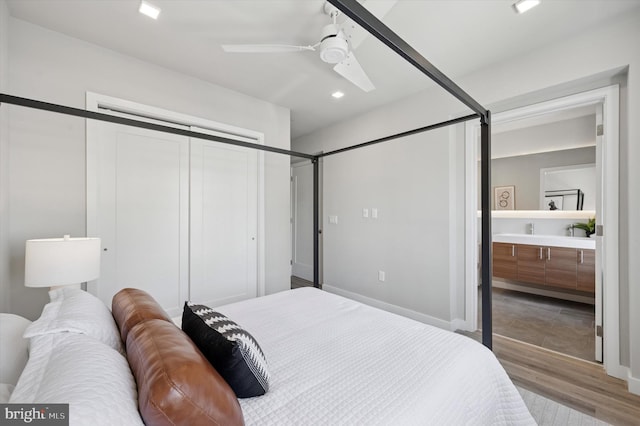 bedroom featuring ensuite bathroom, recessed lighting, wood finished floors, a closet, and ceiling fan