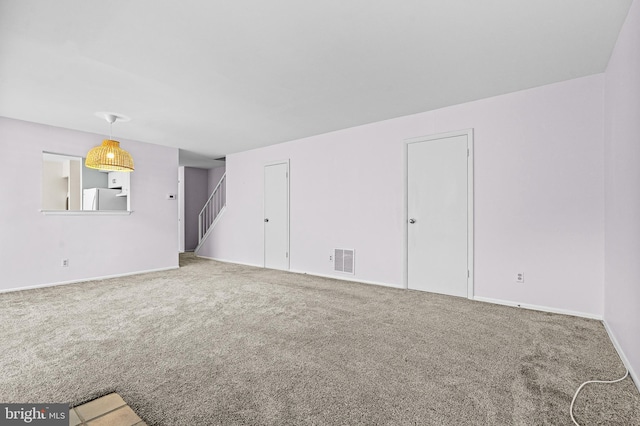 8004 Valley Manor Rd Unit 3C, Owings Mills, MD 21117 - unfurnished living room featuring visible vents, baseboards, stairway, and carpet floors