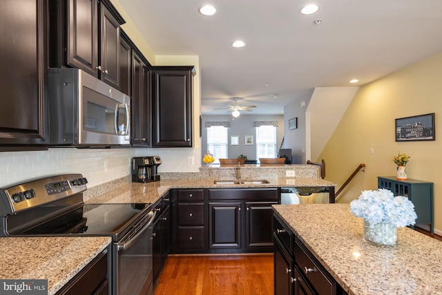 748 S Macon St, Baltimore, MD 21224 - kitchen featuring appliances with stainless steel finishes, a sink, dark wood-style flooring, light stone countertops, and a ceiling fan