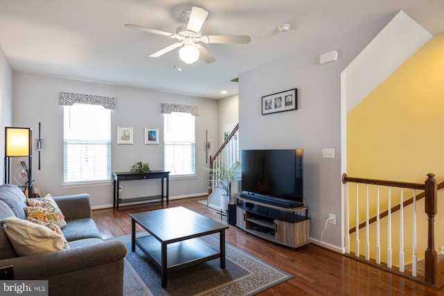 748 S Macon St, Baltimore, MD 21224 - living room featuring dark wood finished floors, baseboards, ceiling fan, and stairs