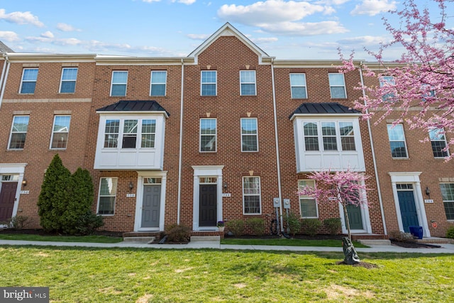 748 S Macon St, Baltimore, MD 21224 - townhome / multi-family property with brick siding and a front lawn