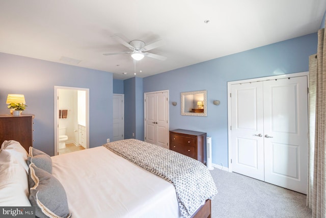 748 S Macon St, Baltimore, MD 21224 - bedroom featuring light colored carpet, two closets, baseboards, a ceiling fan, and ensuite bathroom