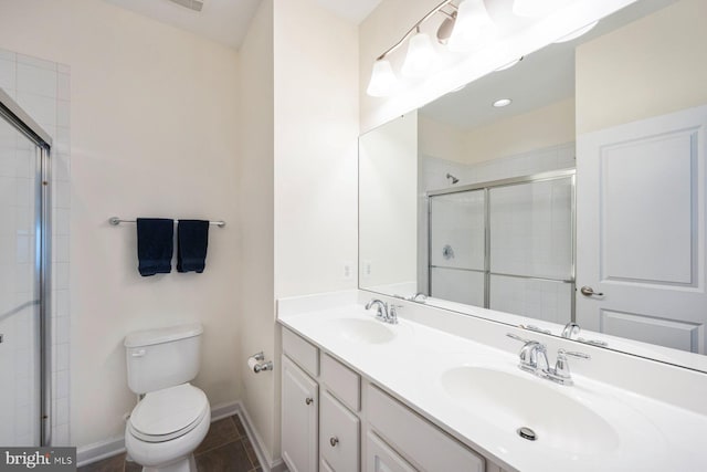 748 S Macon St, Baltimore, MD 21224 - bathroom featuring double vanity, a tile shower, toilet, and baseboards