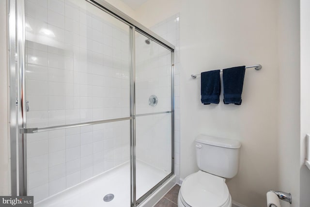 748 S Macon St, Baltimore, MD 21224 - full bath with toilet, a shower stall, and baseboards