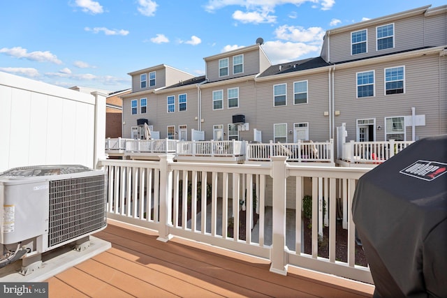 748 S Macon St, Baltimore, MD 21224 - wooden deck featuring central AC unit and a residential view