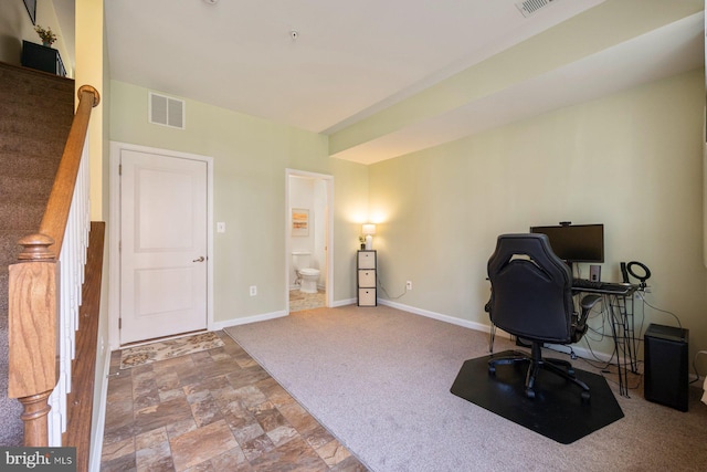 748 S Macon St, Baltimore, MD 21224 - carpeted home office with baseboards and stone finish floors
