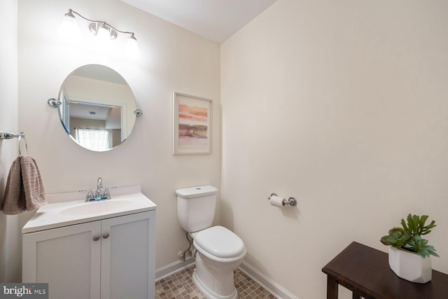 748 S Macon St, Baltimore, MD 21224 - bathroom with toilet, vanity, baseboards, and tile patterned floors
