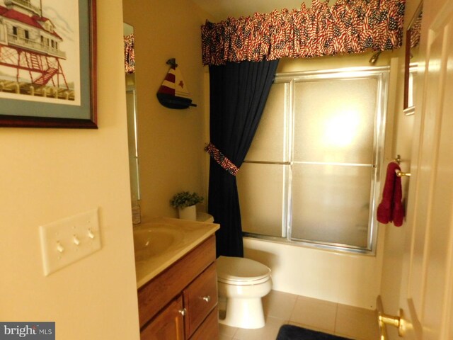 full bathroom with vanity, toilet, tile patterned flooring, and combined bath / shower with glass door