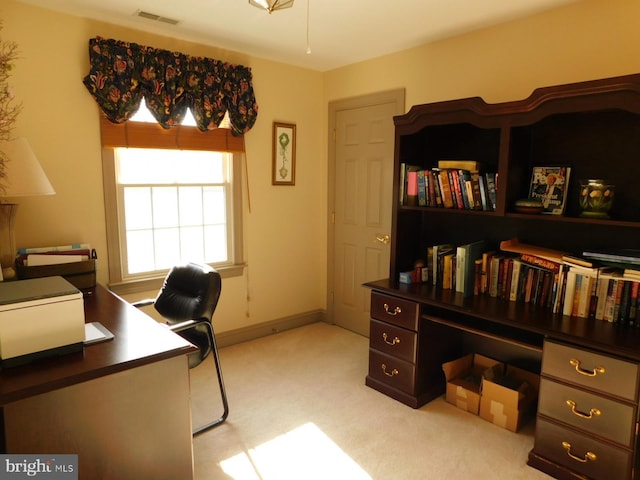 office space with visible vents and light carpet