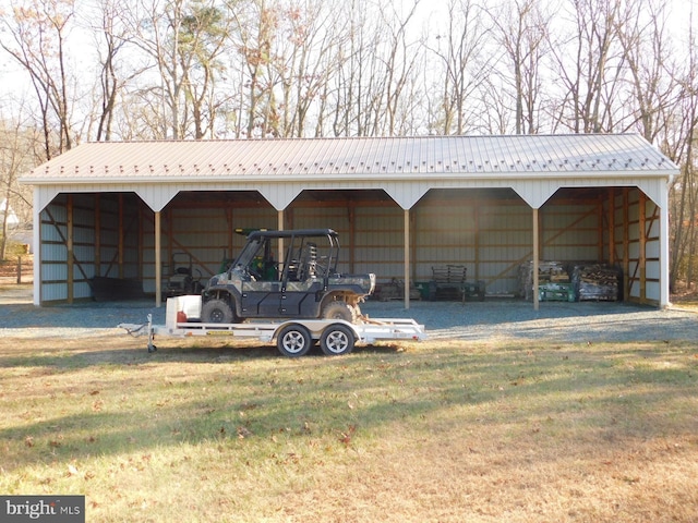 view of parking / parking lot with a carport and a pole building