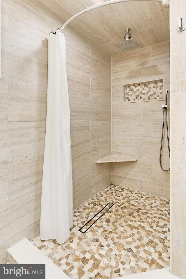 bathroom with tiled shower