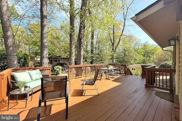 wooden terrace with outdoor lounge area and outdoor dining area