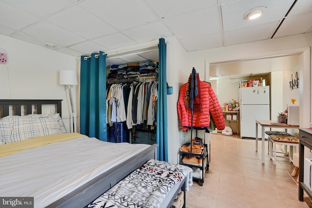 4315 Washington Blvd, Halethorpe, MD 21227 - bedroom featuring freestanding refrigerator, a drop ceiling, a closet, and tile patterned floors