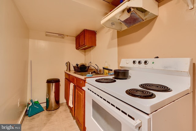 4315 Washington Blvd, Halethorpe, MD 21227 - kitchen featuring white electric range, under cabinet range hood, brown cabinetry, a sink, and light countertops