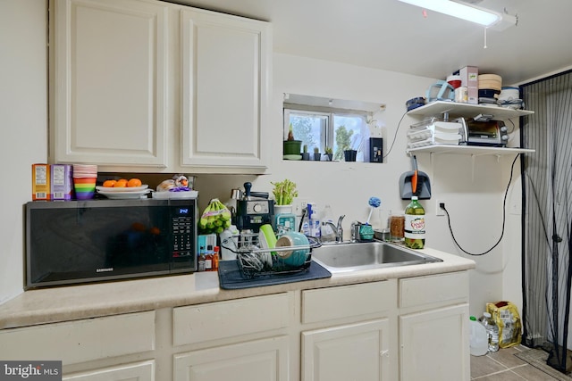 4315 Washington Blvd, Halethorpe, MD 21227 - kitchen featuring a sink, open shelves, light tile patterned flooring, white cabinets, and light countertops