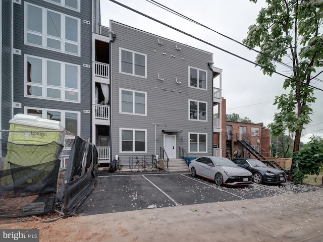 2109 M St NE Unit 5, Washington, DC 20002 - view of property with uncovered parking, entry steps, and fence