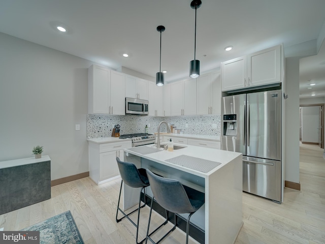 2109 M St NE Unit 5, Washington, DC 20002 - kitchen featuring stainless steel appliances, a sink, light wood finished floors, light countertops, and recessed lighting
