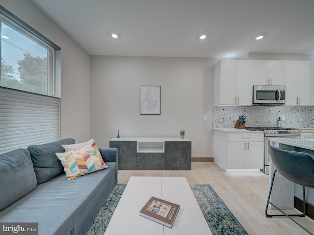 2109 M St NE Unit 5, Washington, DC 20002 - living room featuring light wood finished floors, recessed lighting, and baseboards