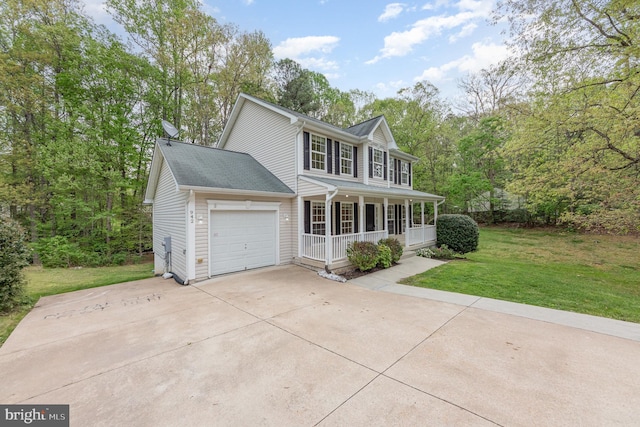 colonial inspired home with concrete driveway, a porch, a front yard, and a garage