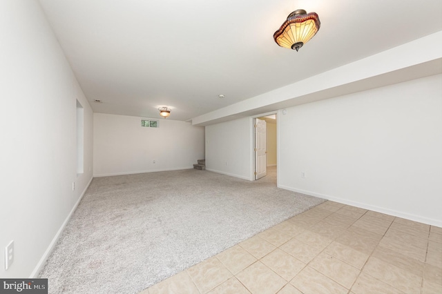 finished basement with baseboards and light colored carpet