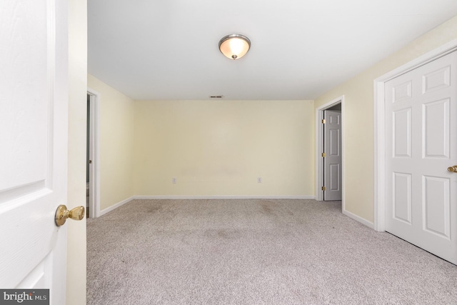 carpeted empty room with baseboards
