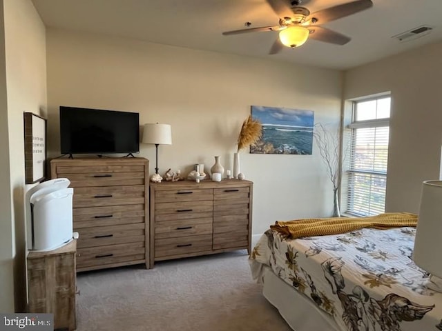 bedroom featuring light carpet, a ceiling fan, and visible vents