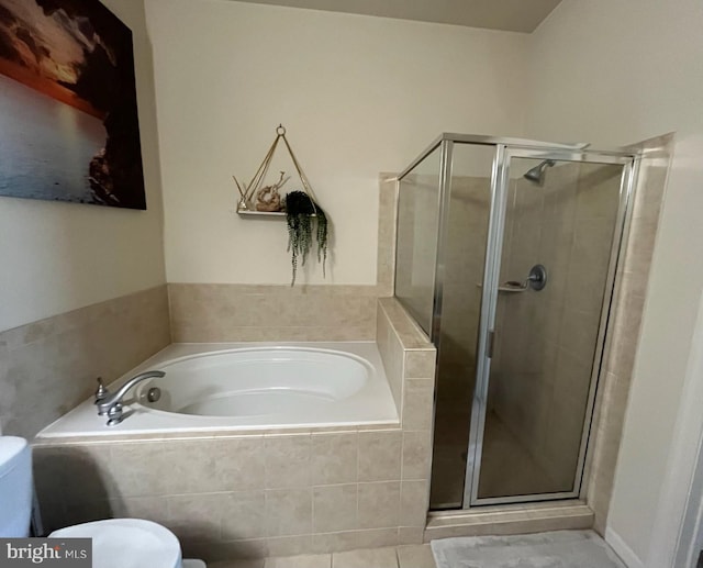 bathroom with a bath, toilet, tile patterned floors, and a stall shower