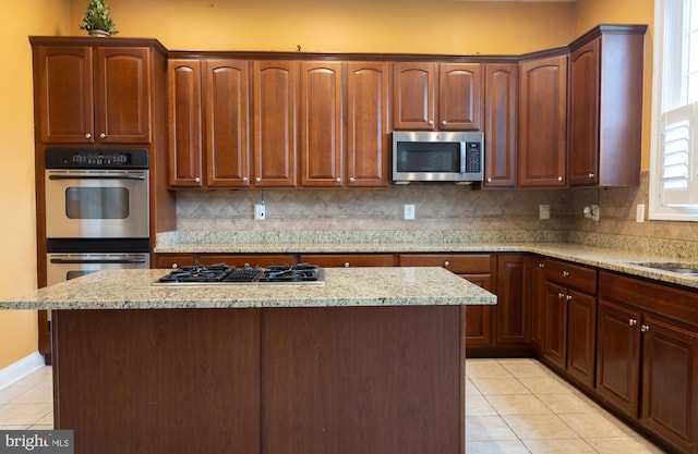 3701 Spicebush Way, Frederick, MD 21704 - kitchen with appliances with stainless steel finishes, light tile patterned floors, tasteful backsplash, and a center island