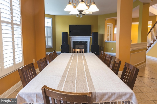 3701 Spicebush Way, Frederick, MD 21704 - tiled dining area with a chandelier, baseboards, a high end fireplace, and stairs