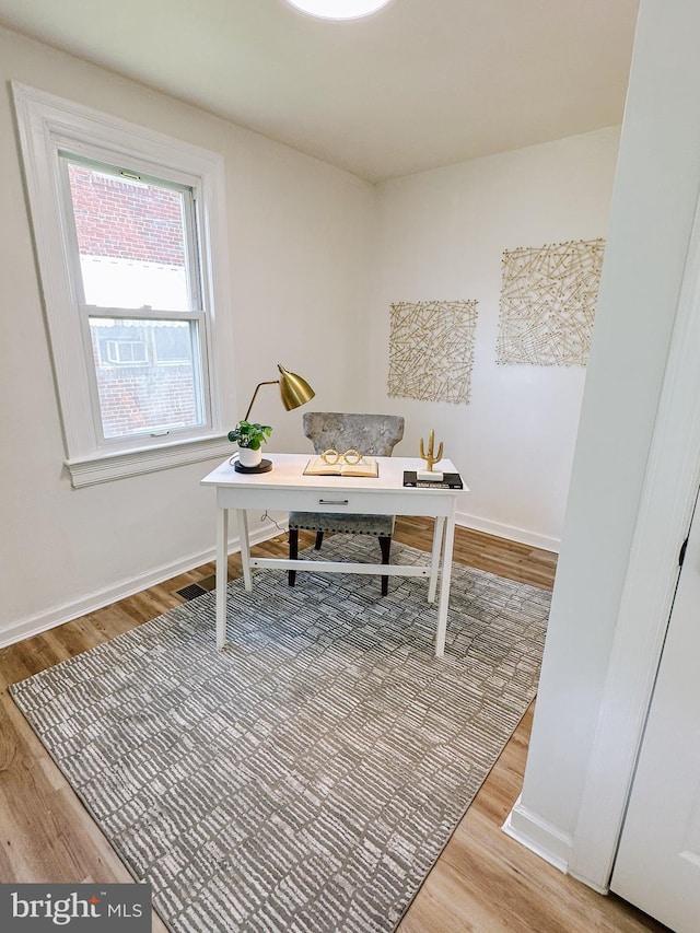 office with wood finished floors and baseboards