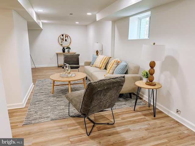 living room featuring recessed lighting, baseboards, and light wood-style floors