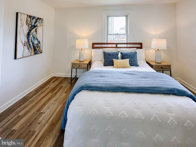 bedroom featuring wood finished floors and baseboards