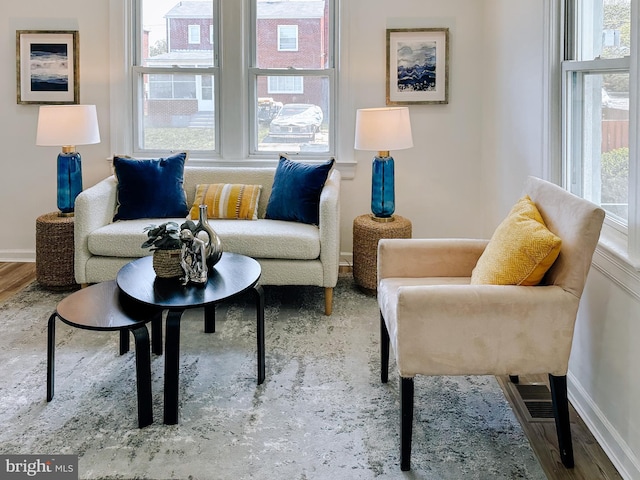 sitting room with wood finished floors and baseboards