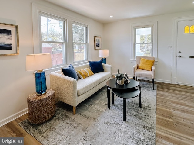 living area featuring wood finished floors, recessed lighting, and baseboards