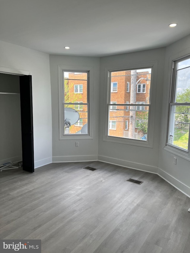 unfurnished bedroom with baseboards, recessed lighting, and wood finished floors