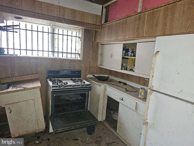 kitchen featuring freestanding refrigerator and gas range
