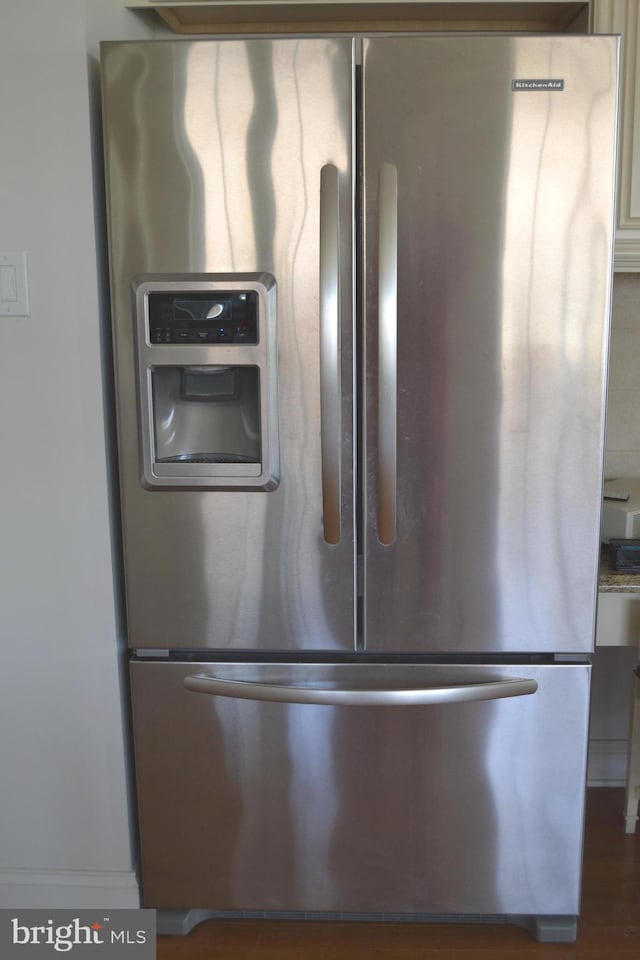 details featuring stainless steel refrigerator with ice dispenser