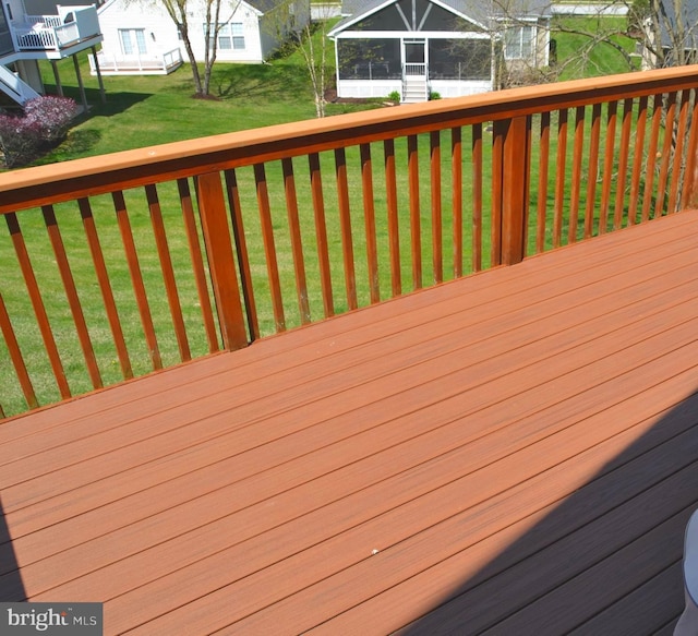 wooden deck featuring a yard and a residential view
