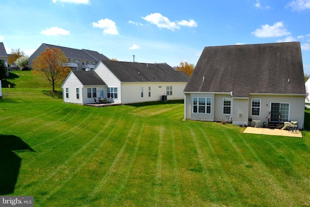 back of house with a yard and a patio area