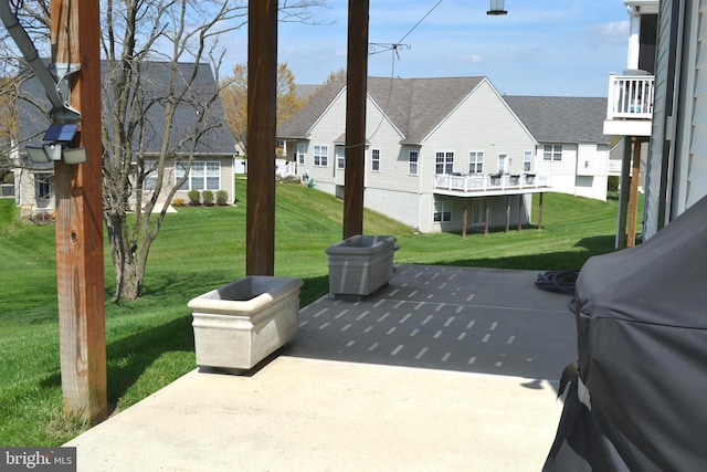 view of patio / terrace featuring a residential view and a grill
