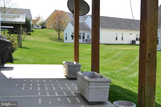 view of yard featuring central AC and a patio area