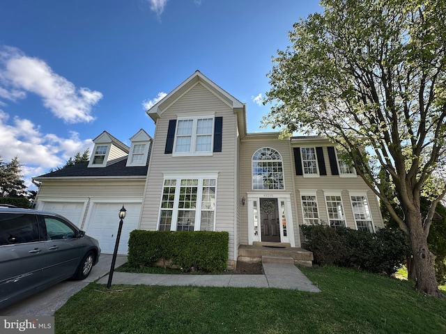 traditional-style home featuring an attached garage and a front lawn