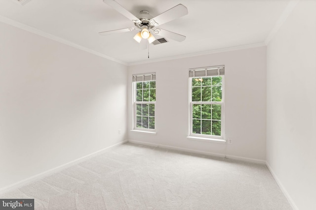 carpeted empty room featuring baseboards, ornamental molding, and ceiling fan