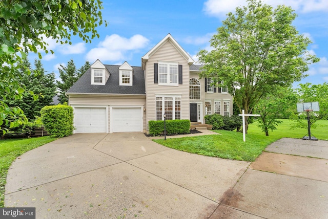 traditional home with a front yard, driveway, an attached garage, and roof with shingles