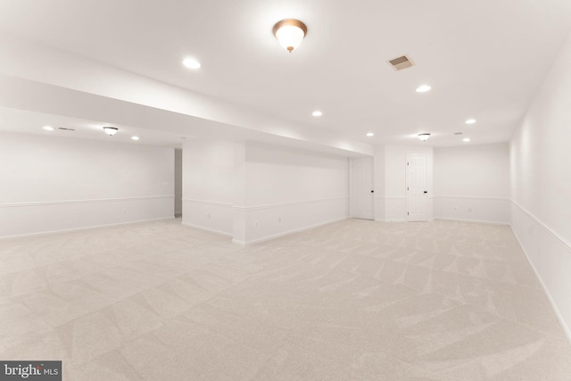finished below grade area featuring light colored carpet, recessed lighting, and baseboards